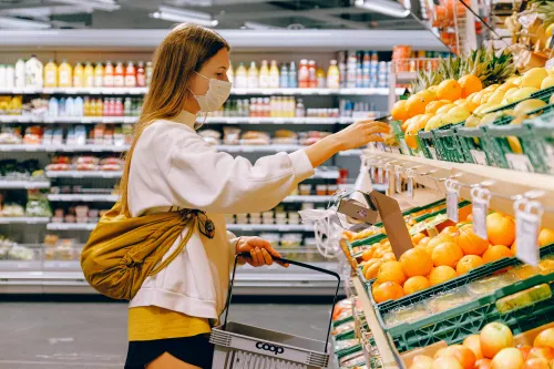 Person, die im Supermarkt nach Angeboten sucht