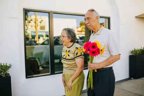 Senior couple walking with caregiver